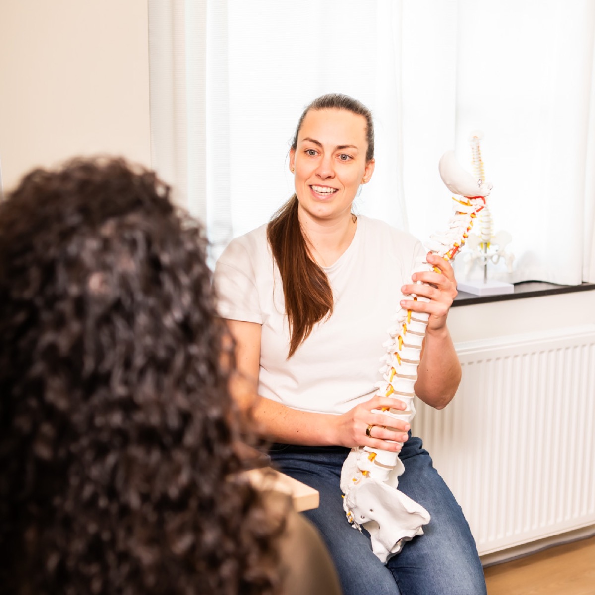 Chiropractor bespreekt het persoonlijke zorgplan met een cliënt bij TOPCHIRO Ede